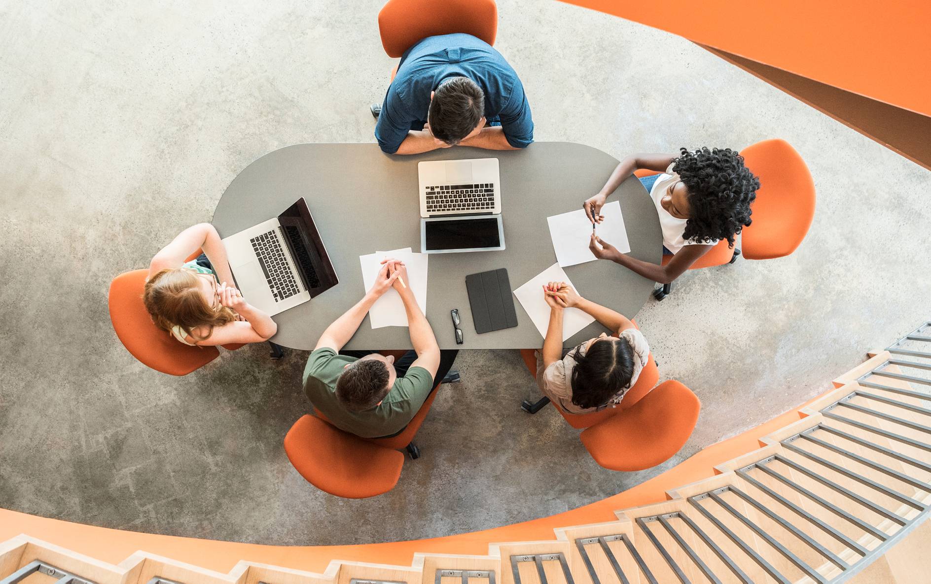 People on orange chair having a meeting