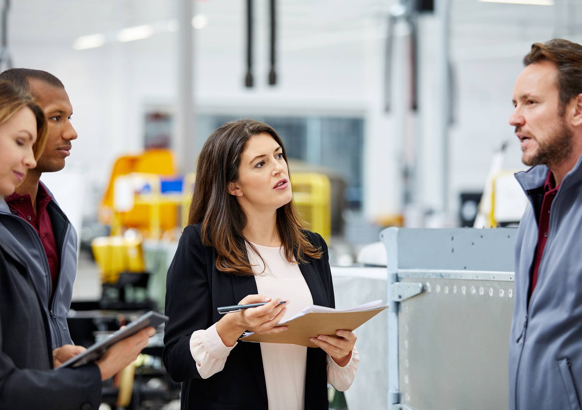 Group of people discussing in factory
