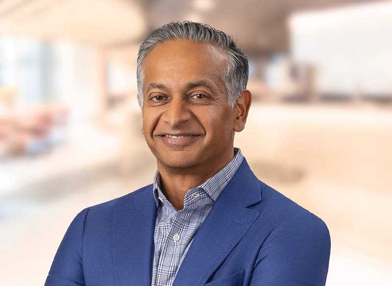 Photo of Sandeep Gupta in a warm office background