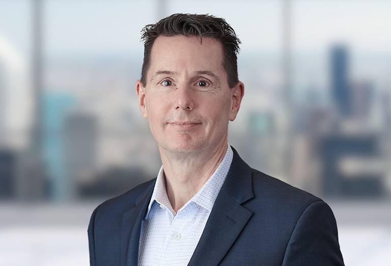 Picture of Chris Ciannella in front of a blurred office image